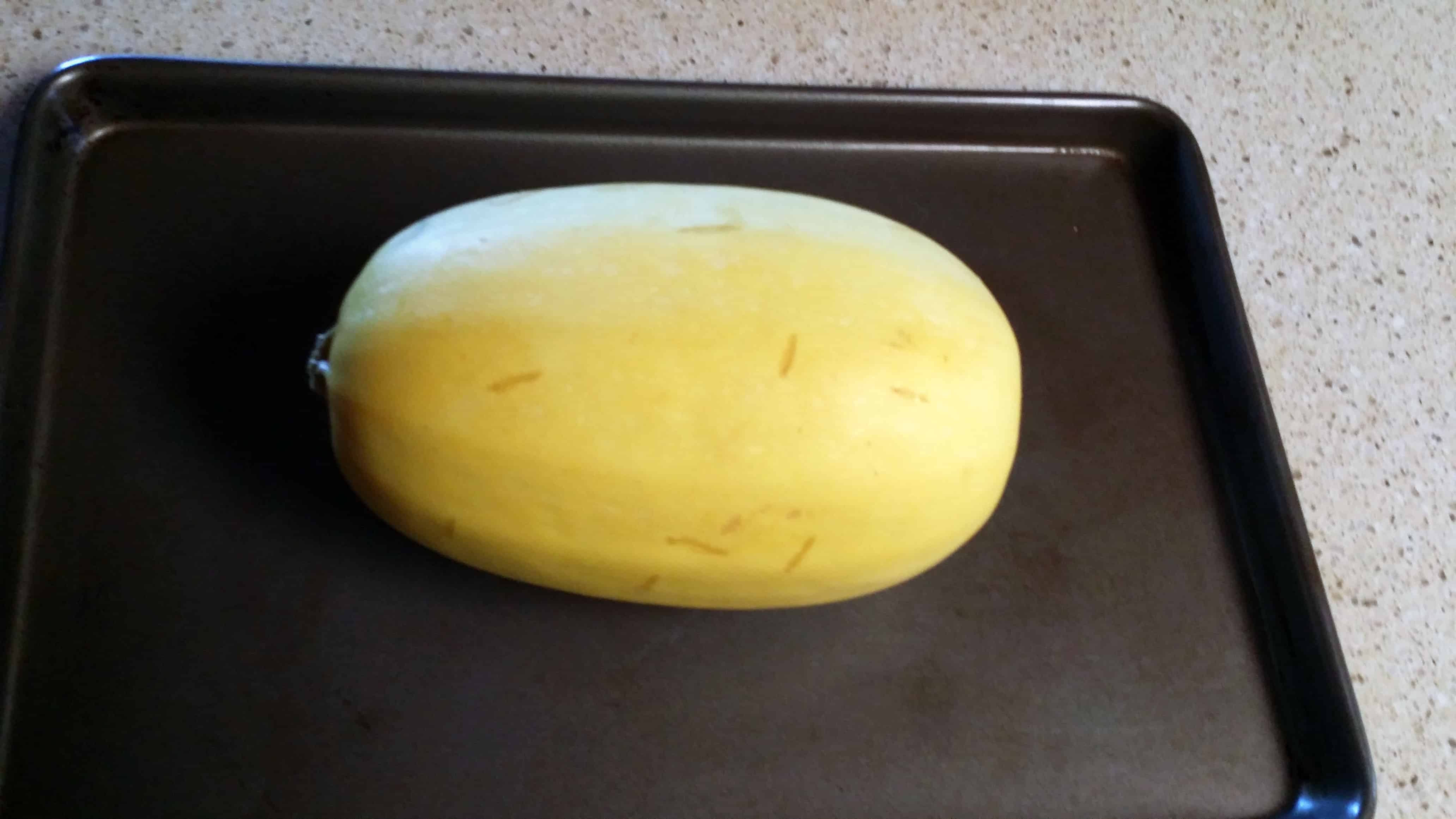 Place spaghetti squash on rimmed baking sheet