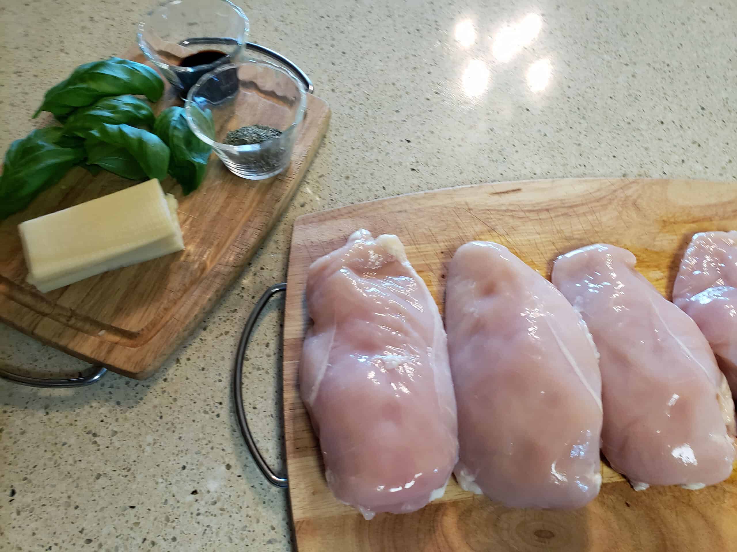 ingredients for baked stuffed chicken on cutting boards