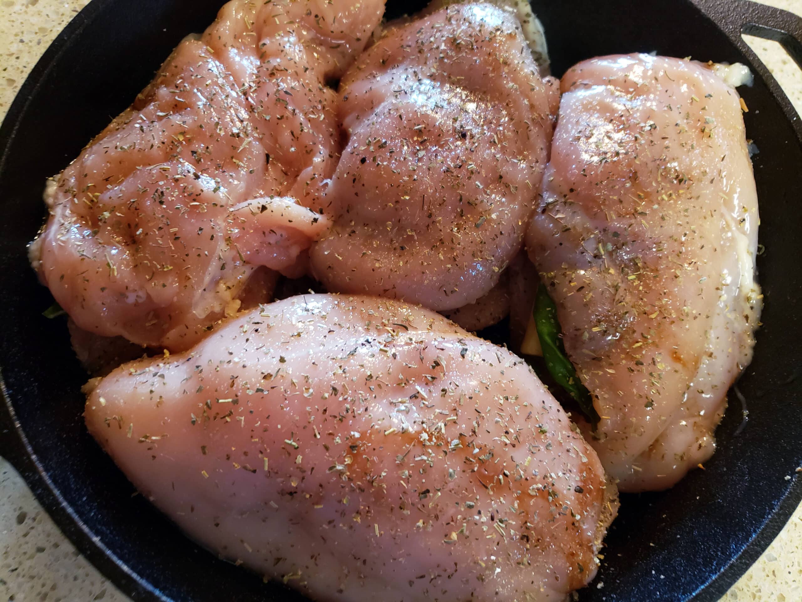 Stuffed chicken breasts in a cast iron skillet